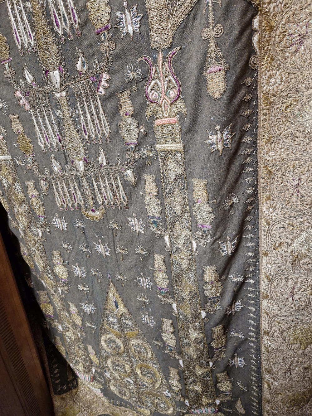 AN INDIAN PANEL SEWN IN GOLD THREAD AND COLOURED SILKS WITH A CANDELABRUM ABOVE A LEAF WITHIN AN - Image 2 of 5