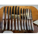 A SET OF THREE SILVER HANDLED STAINLESS STEEL TABLE KNIVES BY GARRARDS, SHEFFIELD 1941, THREE