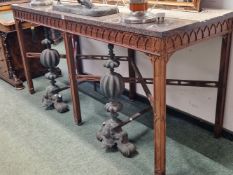 A GRANITE TOPPED ROSEWOOD CONSOLE TABLE, THE APRON CARVED WITH AN OGEE ARCH BAND ABOVE SIX SQUARE