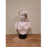 A 19th C. WHITE MARBLE BUST OF A LADY WEARING A ROSE IN HER LACE TRIMMED BODICE SUPPORTED ON A BLACK