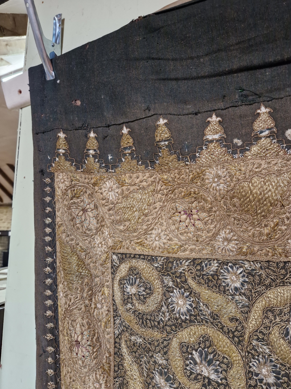 AN INDIAN PANEL SEWN IN GOLD THREAD AND COLOURED SILKS WITH A CANDELABRUM ABOVE A LEAF WITHIN AN - Image 5 of 5