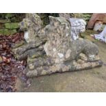 A PAIR OF OLD WEATHERED GARDEN FIGURES OF LARGE RECUMBENT LIONS.