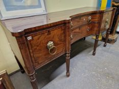 AN EARLY 19th C. MAHOGANY SIDE BOARD, THE CENTRAL INCURVED DRAWERS AND FLANKING DRAWERS INLAID IN