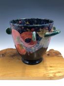 A WILLIAM MOORCROFT TWO HANDLED TALL BOWL APPLIED WITH GREEN SEMICIRCULAR LUGS BELOW THE RIM. H