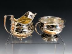 A GEORGE III SILVER CREAM BOAT, THE LONDON MARKS WORN AND A SILVER CUP BY THE GOLDSMITHS AND