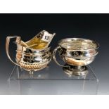 A GEORGE III SILVER CREAM BOAT, THE LONDON MARKS WORN AND A SILVER CUP BY THE GOLDSMITHS AND