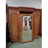 A VICTORIAN MAHOGANY BREAKFRONT COMPACTUM, THE CENTRAL MIRRORED DOOR FLANKED BY PANELLED DOORS