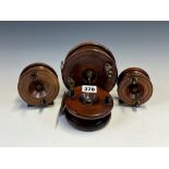 FOUR WOODEN FISHING REELS, THE LARGEST. Dia. 12.5cms. AND THE SMALLEST 7.5cms.
