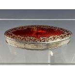 A RED ENAMELLED OVAL SILVER BOX BY JULIUS ROSENTHAL, LONDON 1933, THE BASSE TAILLE HINGED LID WITH A