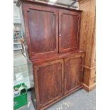 A 19th C. MAHOGANY PRESS, THE DOORS TO THE RECESSED UPPER HALF AND THE BASE CLOSING ON A BRASS