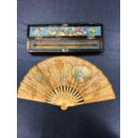 A CHINESE CASED FAN WITH BONE STICKS, THE LEAF PAINTED WITH A LADY AND FRAMES OF BIRDS TOGETHER WITH