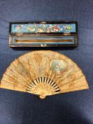 A CHINESE CASED FAN WITH BONE STICKS, THE LEAF PAINTED WITH A LADY AND FRAMES OF BIRDS TOGETHER WITH