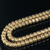 AN ANTIQUE FACET AND BEAD FANCY LINK CHAIN. UNHALLMARKED, ASSESSED AS 11ct GOLD. LENGTH 68cms.