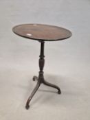 A GEORGE III MAHOGANY TRIPOD TABLE, THE DISHED CIRCULAR TOP ON A BALUSTER COLUMN, THE DOWNSWEPT LEGS