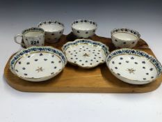 THREE LOWESTOFT TEA BOWLS, A COFFEE CUP, TWO SAUCERS AND A TEA POT STAND. ALL PAINTED WITH