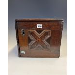 AN 18th C. OAK TABLE TOP CABINET, THE X-SHAPED PANELLED DOOR OPENING ONTO SIX DRAWERS AND TWO PIGEON