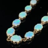 A HALLMAKKED 9ct GOLD SIXTEEN STONE OVAL CABOCHON CUT OPAL BRACELET. EACH OPAL IN A VICTORIAN