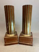 A PAIR OF MAHOGANY COLUMNS, THE FLUTES OF THE CYLINDRICAL SHAPES BRASS LINED ABOVE BRASS EDGED