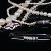 AN ANTIQUE ROW OF GRADUATED CULTURED PEARS, COMPLETE WITH AN ART DECO RUBY AND DIAMOND CLASP. PEAR