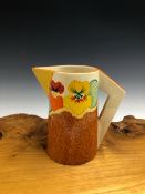 A CLARICE CLIFF NASTURTIUM PATTERN JUG WITH A TRIANGULAR HANDLE AND SPOUT. H 15cms.