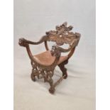 A 19th C. ITALIAN WALNUT CHAIR, THE TOP RAIL CARVED WITH A CENTRAL HELMET ABOVE A STYLISED