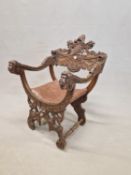 A 19th C. ITALIAN WALNUT CHAIR, THE TOP RAIL CARVED WITH A CENTRAL HELMET ABOVE A STYLISED
