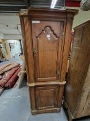 AN EARLY 19th C. PINE CORNER CUPBOARD, THE UPPER OF THE TWO PANELLED DOORS OGEE ARCHED, BOTH BETWEEN