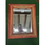 A BEVELLED GLASS RECTANGULAR MIRROR WITHIN A RED SILK VELVET FRAME. 42 x 34cms.