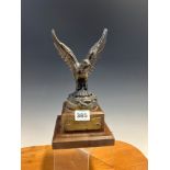 A BRONZED EAGLE ON A MAHOGANY PLINTH WITH THE BRASS LABELS INSCRIBED THE EAGLE HAS LANDED, NEIL