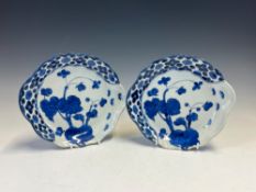 A PAIR OF JAPANESE ARITA PLATES, EACH PAINTED WITH BUTTERFLIES APPROACHING STEMS OF FLOWERS WITHIN A