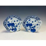 A PAIR OF JAPANESE ARITA PLATES, EACH PAINTED WITH BUTTERFLIES APPROACHING STEMS OF FLOWERS WITHIN A