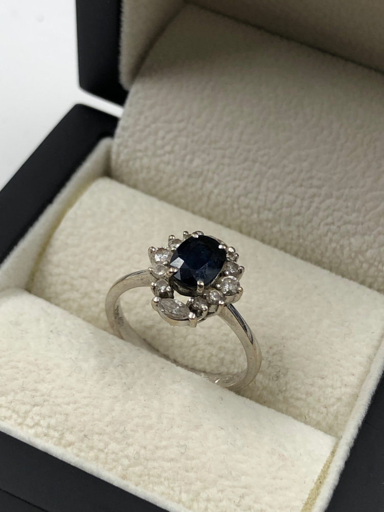 A SAPPHIRE AND DIAMOND CLUSTER RING. THE OVAL SAPPHIRE IN A FOUR CLAW SETTINGS, SURROUNDED BY TWO - Image 7 of 7