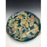 A LISE B MOORCROFT 1992 DISH SLIP TRAILED WITH FISH ON A BLUE GROUND. Dia 41cms.