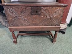AN 18th C. OAK COFFER, THE FRONT CARVED WITH INITIALS BELOW THE LOCK PLATE AND FLANKED BY