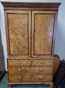 A 19th C. BURR WOOD LINEN PRESS, THE DOORS OF THE TOP ENCLOSING FIVE SLIDES, THE TWO SHORT AND TWO