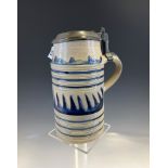A WESTERWALD TYPE BLUE AND WHITE LITRE TANKARD, THE PEWTER LID WITH SCRATCHED INITIALS AND THE
