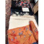 TWO CHINESE EMBROIDERED BLACK GROUND SILK SHAWLS, ANOTHER CREAM TOGETHER WITH A ROLL OF CHINESE