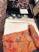 TWO CHINESE EMBROIDERED BLACK GROUND SILK SHAWLS, ANOTHER CREAM TOGETHER WITH A ROLL OF CHINESE