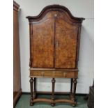 AN 18th C. BURR WALNUT CABINET ON LATER STAND, THE SERPENTINE TOP OVER TWO CROSS BANDED DOORS ENCLO