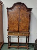 AN 18th C. BURR WALNUT CABINET ON LATER STAND, THE SERPENTINE TOP OVER TWO CROSS BANDED DOORS ENCLO