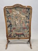 AN EARLY 20th C. MAHOGANY FIRE SCREEN, THE CENTRE OF THE SERPENTINE TOP CARVED WITH FLOWERS, THE