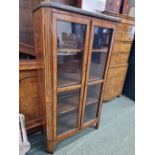 AN ANTIQUE GREY MARBLE TOPPED WALNUT CROSS BANDED ROSEWOOD DISPLAY CABINET, THE TWO GLAZED DOORS B