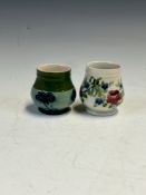 TWO MACINTYRE MOORCROFT SMALL VASES, ONE SLIP TRAILED WITH SWAGS OF FLOWERS AND THE OTHER WITH