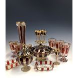 A COLLECTION OF BOHEMIAN GLASS GILT AND OVERLAID BY RUBY PANELS, COMPRISING: FIVE WINE GLASSES,