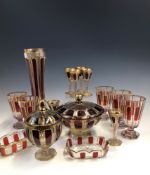 A COLLECTION OF BOHEMIAN GLASS GILT AND OVERLAID BY RUBY PANELS, COMPRISING: FIVE WINE GLASSES,