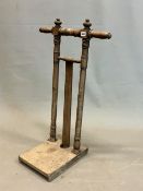 A 19th C. MAHOGANY BOOT JACK WITH A TWO HANDLED TOP ON TWO COLUMNS JOINED AT THE BASE BY A
