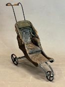 A VICTORIAN DOLLS THREE IRON WHEELED DOG CART WITH A HOOD TO DRAW UP OVER THE BUTTONED BLACK