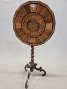 A VICTORIAN TILT TOP TRIPOD TABLE, THE POLYGONAL TOP WITH FLORAL MARQUETRY WITHIN A RADIATING BAND