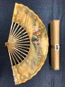 A BOXED FAN WITH MOTHER OF PEARL STICKS, THE PAPER LEAF PAINTED WITH A GARDEN GATHERING OF 18th C.