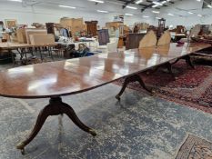 A 19th C. MAHOGANY D-END DINING TABLE SUPPORTED ON FOUR COLUMNS, EACH WITH THREE LEGS AND BRASS